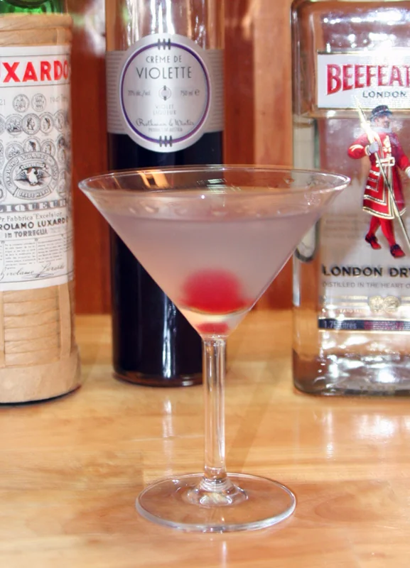 An Aviation cocktail — gin, maraschino, crème de violette, and lemon juice in a coupe glass