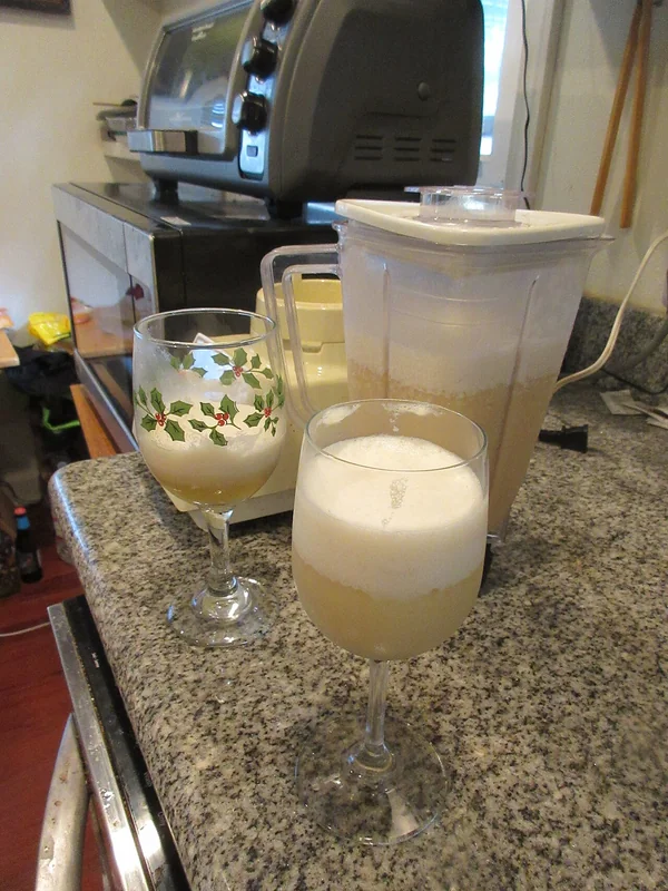 Piña coladas being blended in a home kitchen blender, illustrating the blending mixing technique