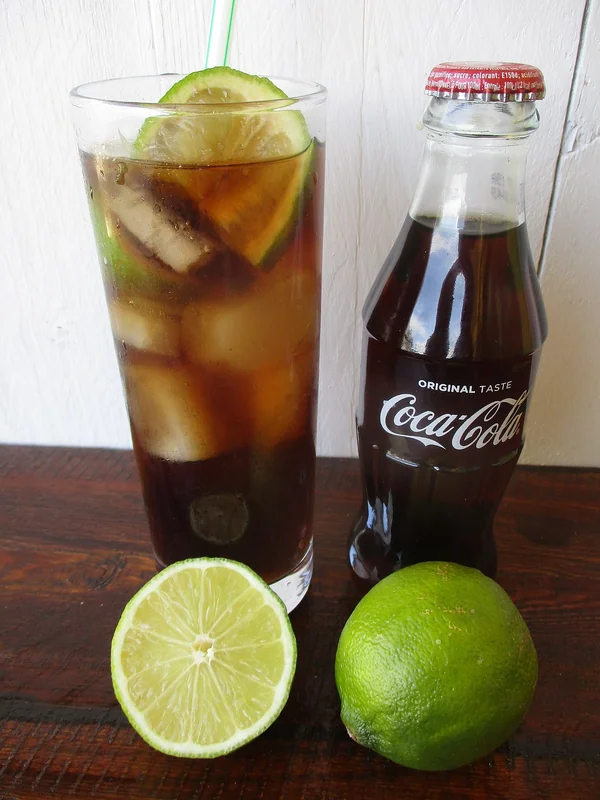 A Cuba Libre highball built directly in the glass over ice, an example of the building technique