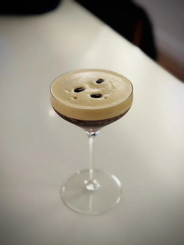 An Espresso Martini cocktail with coffee bean garnish