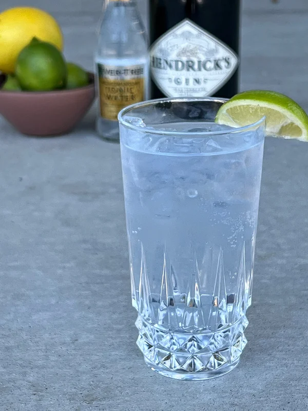 A gin and tonic with a wedge of lime, the classic showcase for gin as a base spirit