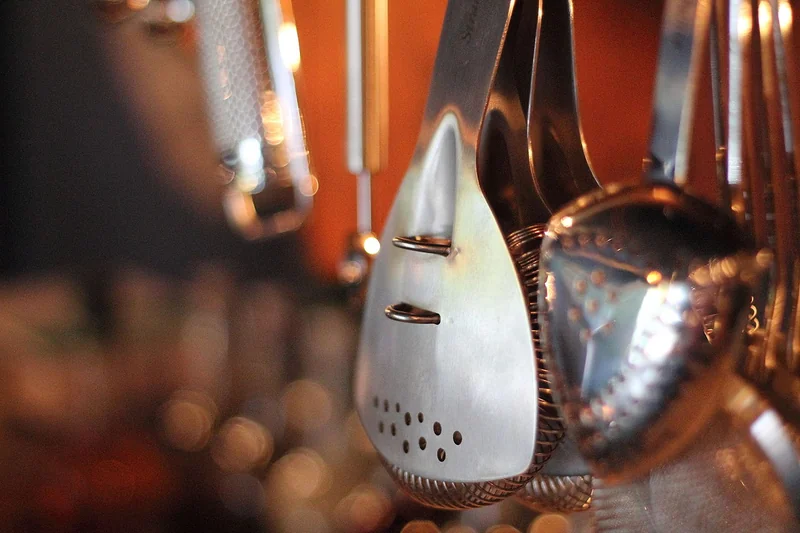 A Hawthorne strainer — the spring-coil bar tool for straining shaken cocktails
