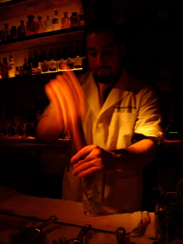 Mint and fruit being muddled in a glass to release flavour for a cocktail
