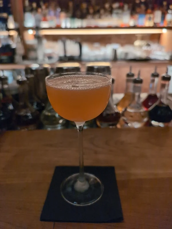 A Naked and Famous, an equal-parts modern cocktail of mezcal, yellow Chartreuse, Aperol and lime