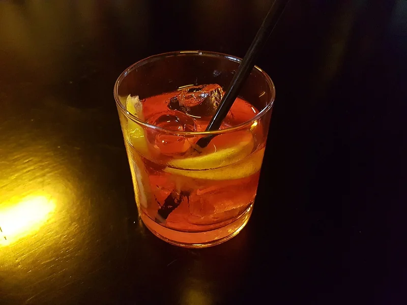 A Negroni cocktail with orange peel garnish