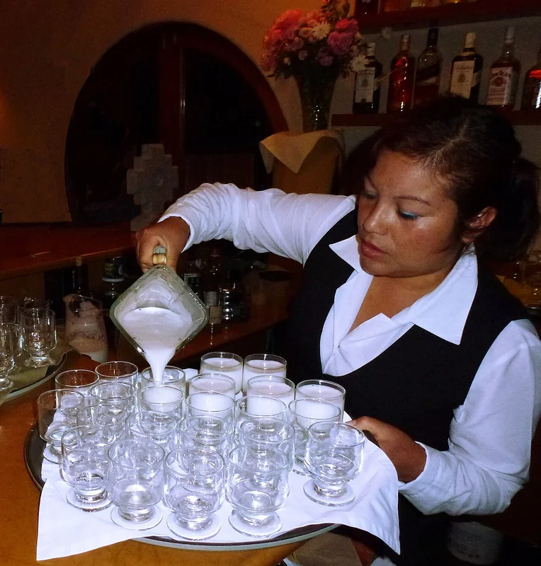 A Pisco Sour being prepared with egg white foam