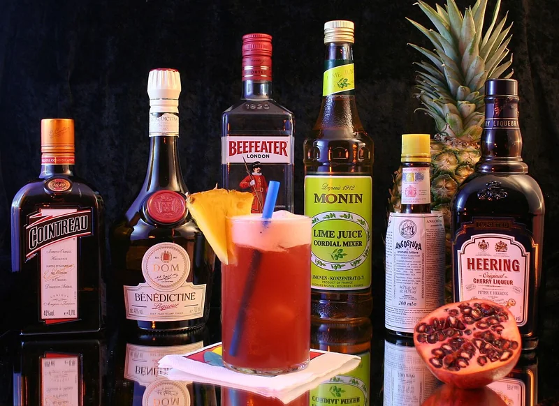 Singapore Sling cocktail ingredients including gin, cherry brandy, and Bénédictine
