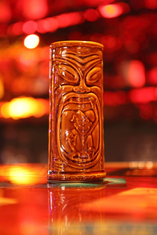 A decorative ceramic tiki mug, emblematic of the mid-century tiki cocktail movement