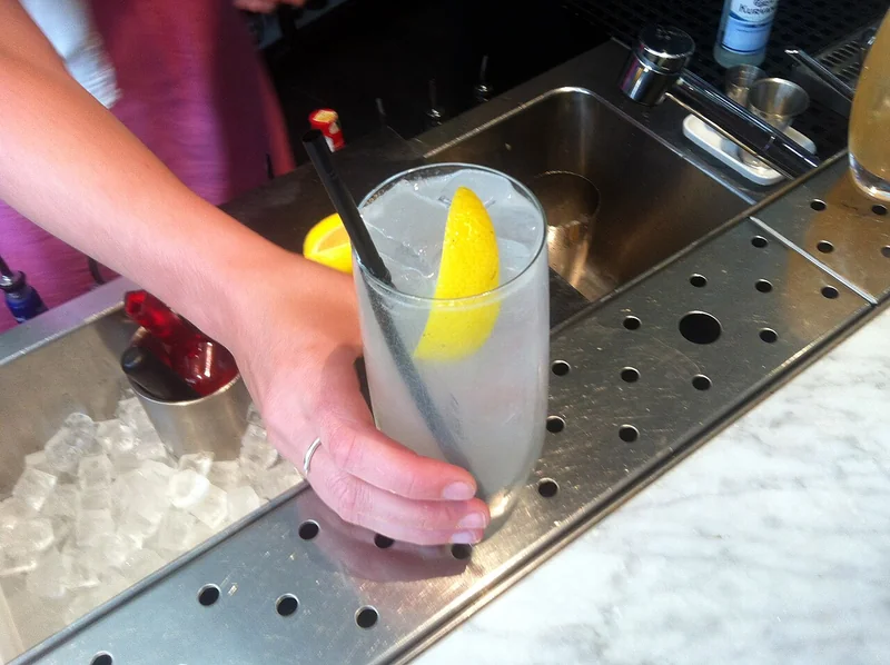 A Tom Collins cocktail in a tall Collins glass
