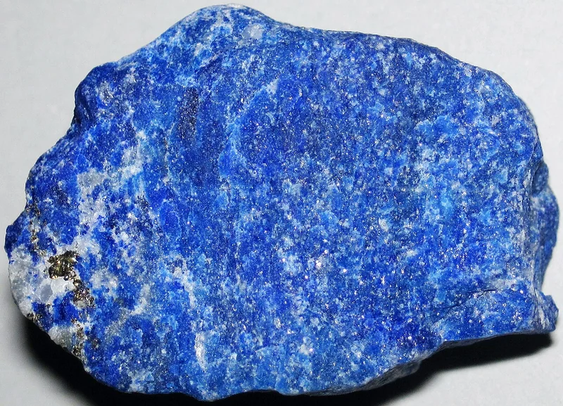 Polished lapis lazuli slab showing deep blue colour with pyrite and calcite inclusions