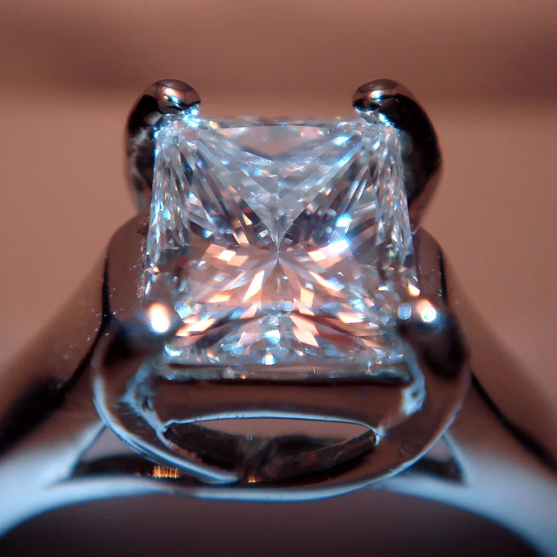 Princess-cut diamond showing square outline with pointed corners and brilliant-style faceting