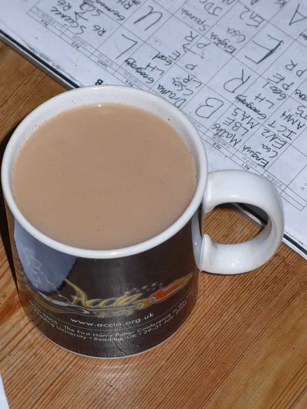 Assam black tea leaves and a cup of brewed tea