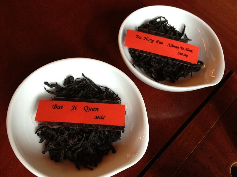 Da Hong Pao oolong tea leaves and a cup of amber infusion