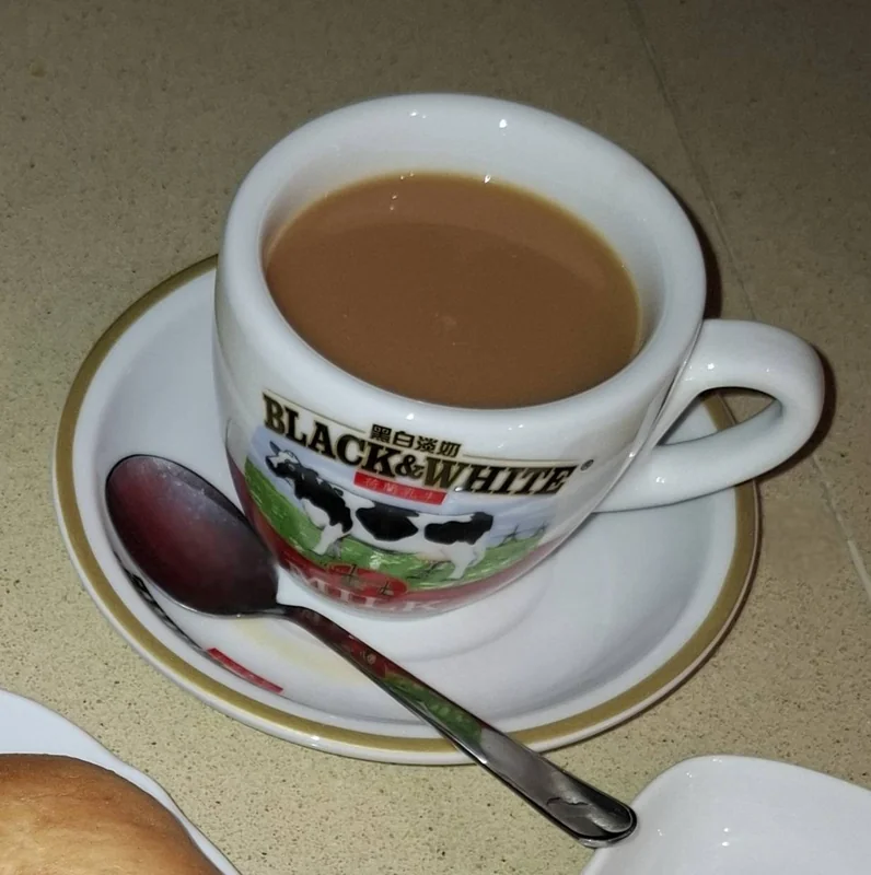 Hong Kong milk tea being strained through cloth silk stocking filter