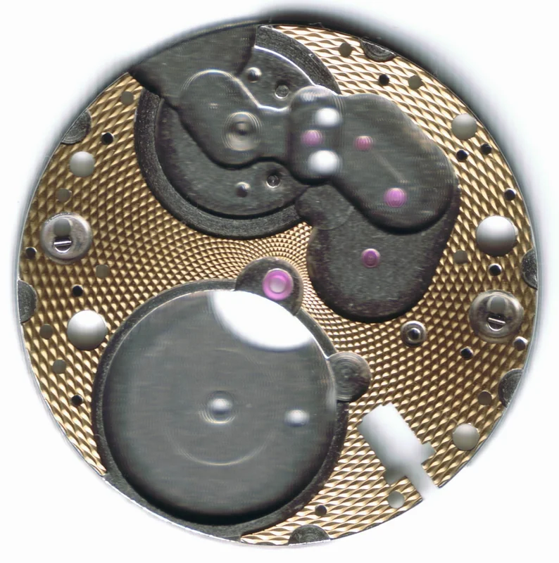 Closeup of a guilloche rose engine pattern showing interlocking geometric waves on metal