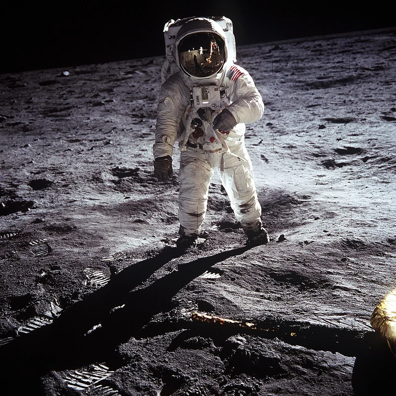 Omega Speedmaster Professional Moonwatch with black dial, tachymeter bezel, and three-register chronograph