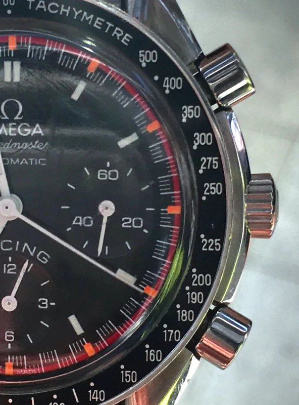 Racing chronograph watch with tachymeter bezel and three-register dial