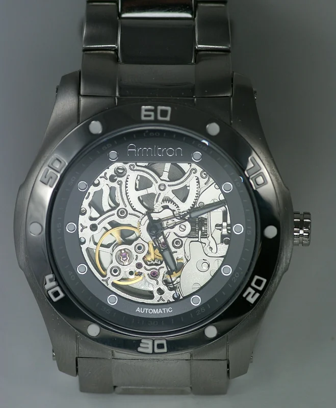 Skeleton watch with openwork dial showing gear train, balance wheel, and decorative bridges